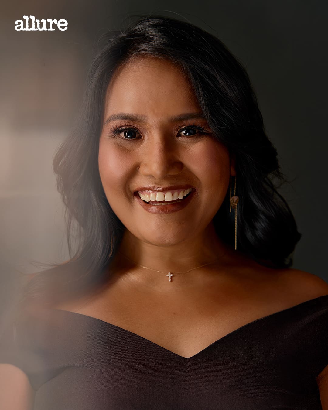 A portrait of a woman, Cherrie Atilano, smiling.