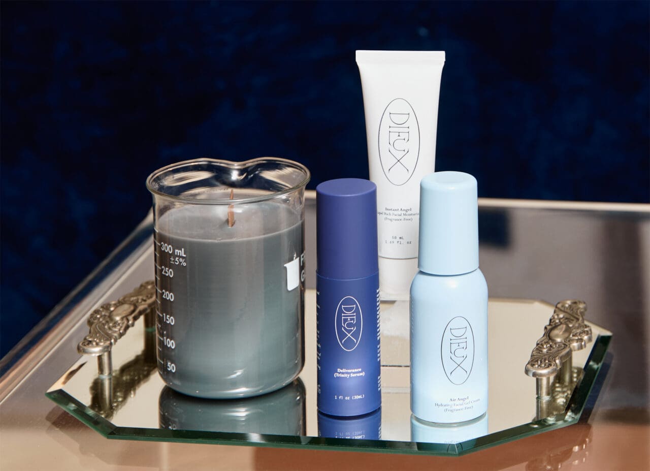 A tray displaying Dieux Skin products: the Deliverance Soothing Trinity Serum, the Instant Angel Moisturizer, and the Air Angel Daily moisturizer.