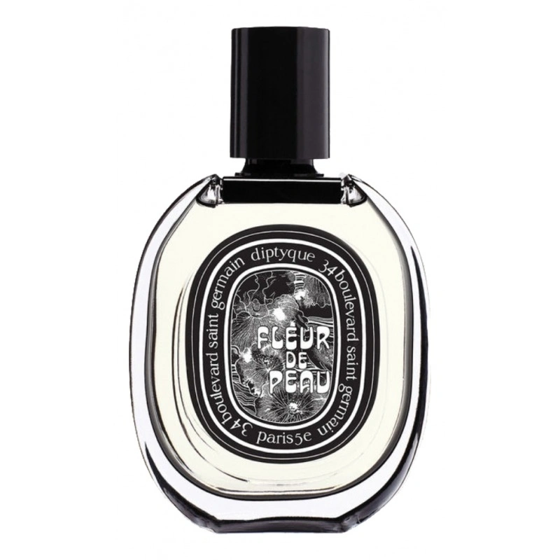 Diptyque perfume bottle Fleur de Peau with a black cap and an ornate black-and-white label on clear glass