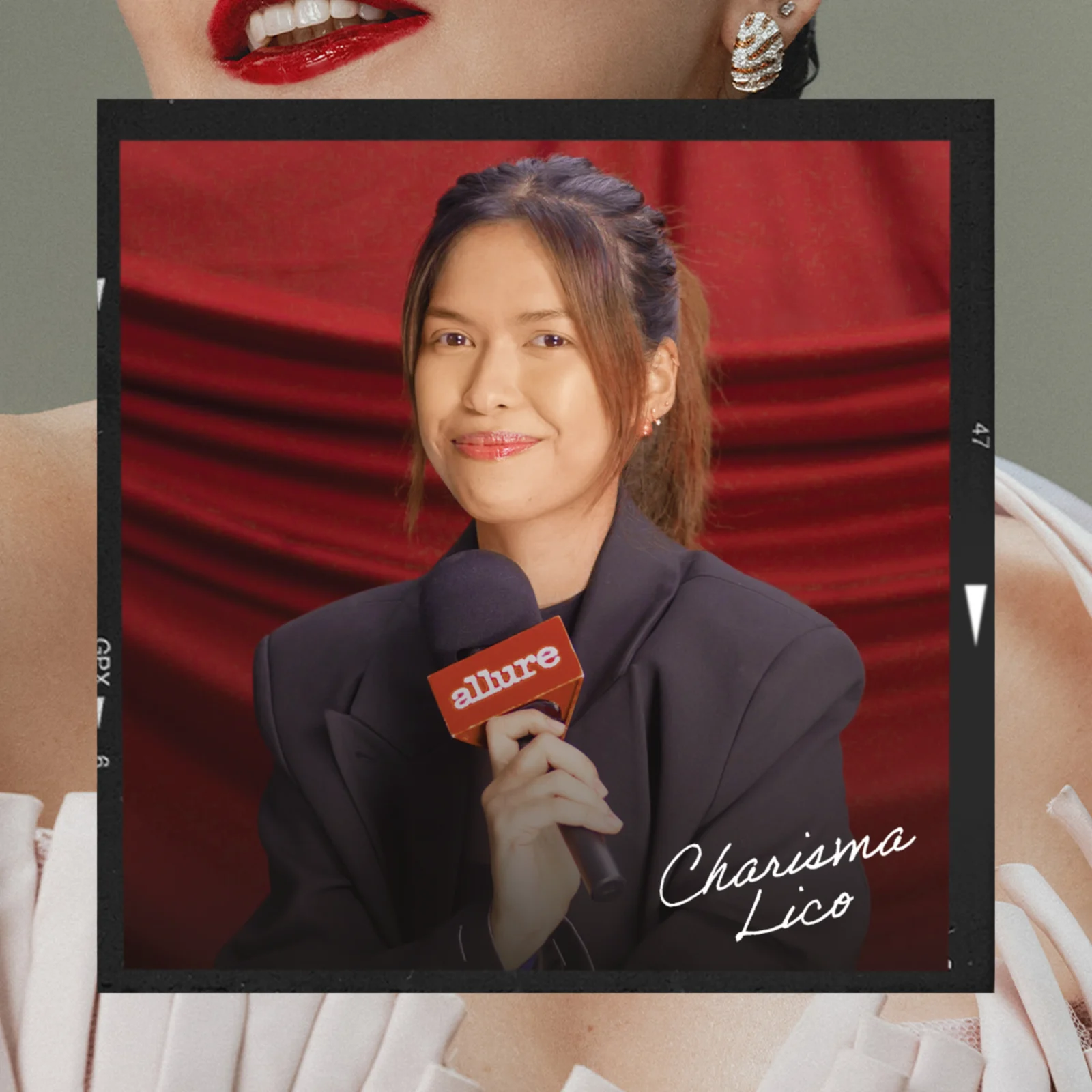 Portrait of a woman in a navy blazer holding an orange Allure microphone against a red studio backdrop.