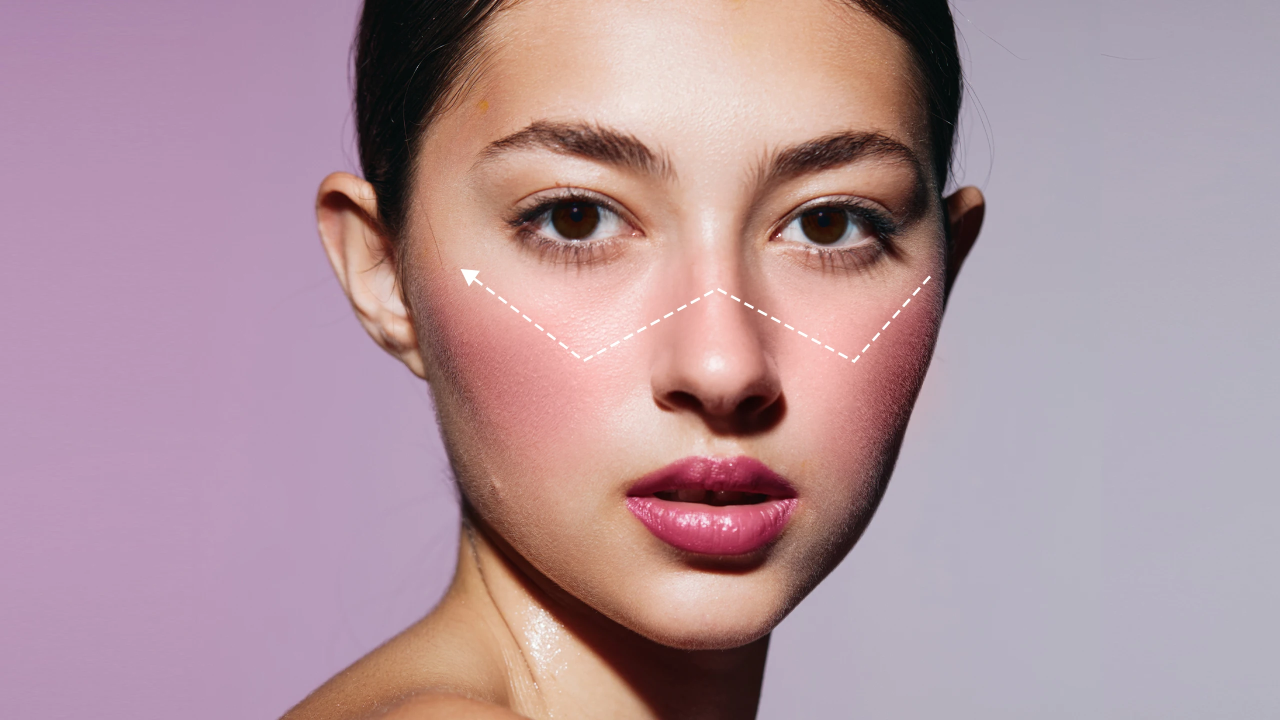Close-up of a woman’s face showing cheek contouring lines with dashed white guides.
