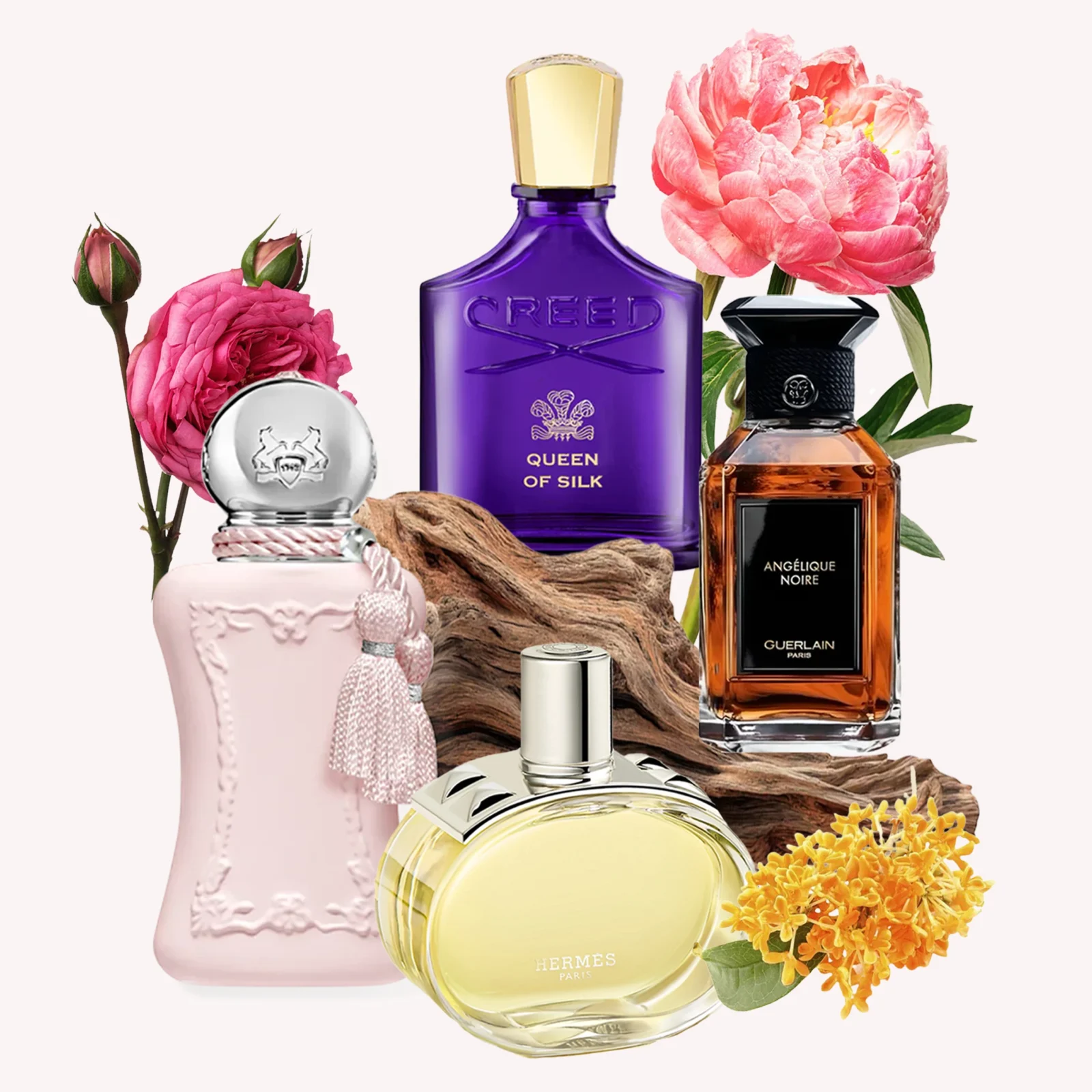 Arrangement of perfume bottles surrounded by pink roses and orange flowers against a pale background, USAGE: fragrance display image.