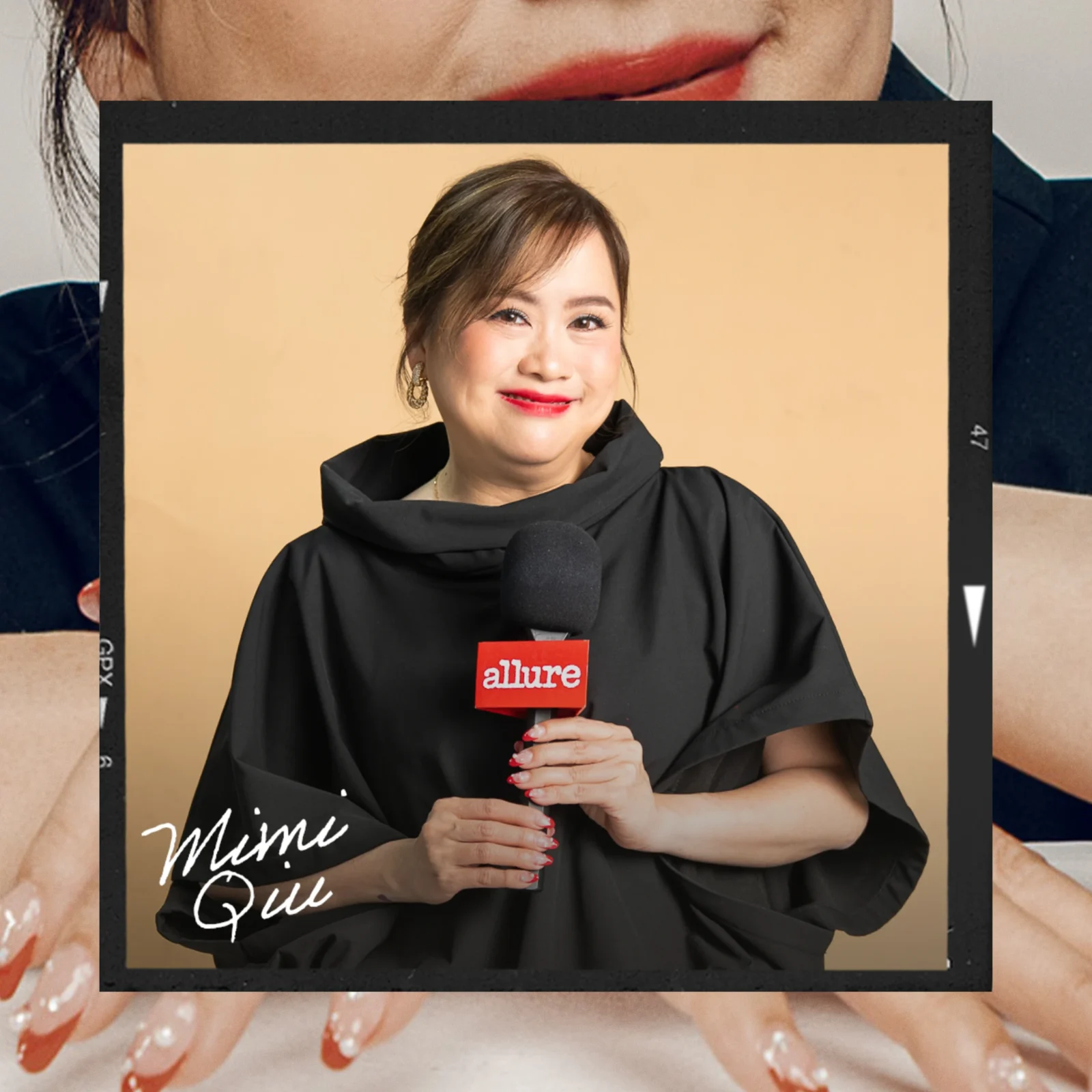 Smiling woman in a black outfit holding a microphone with a red Allure label against a beige backdrop.