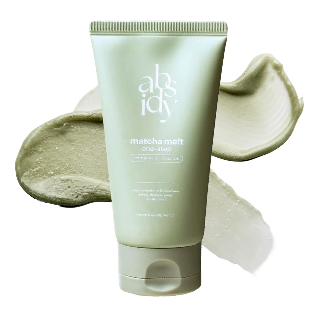 Green cosmetic tube labeled 'matcha melt' with pale swirl cream in the background (product shot).