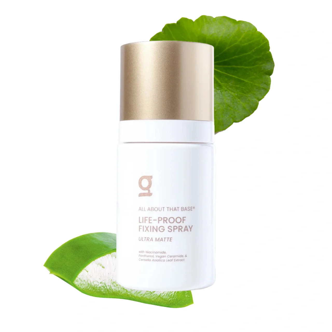 White cosmetic bottle with a metallic gold cap resting on a green leaf against a white background.